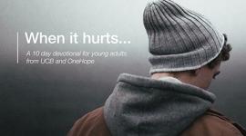 man standing with his back to us with a coat and hat on