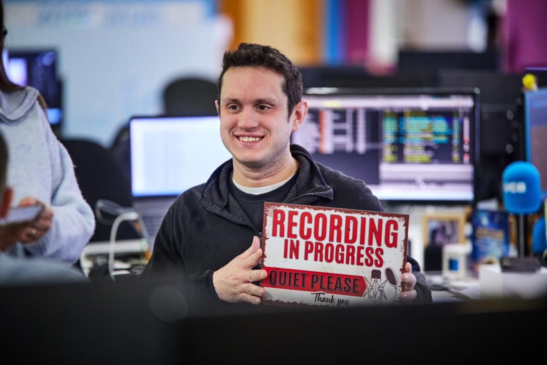 Recording in progress sign held by a UCB staff member